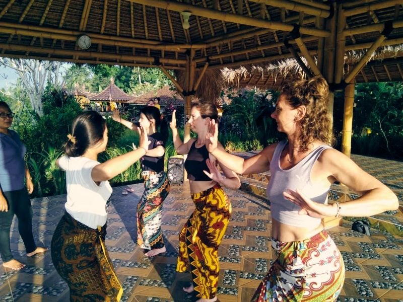 Guests practising Balinese movement in a bamboo pavilion at Balitrees