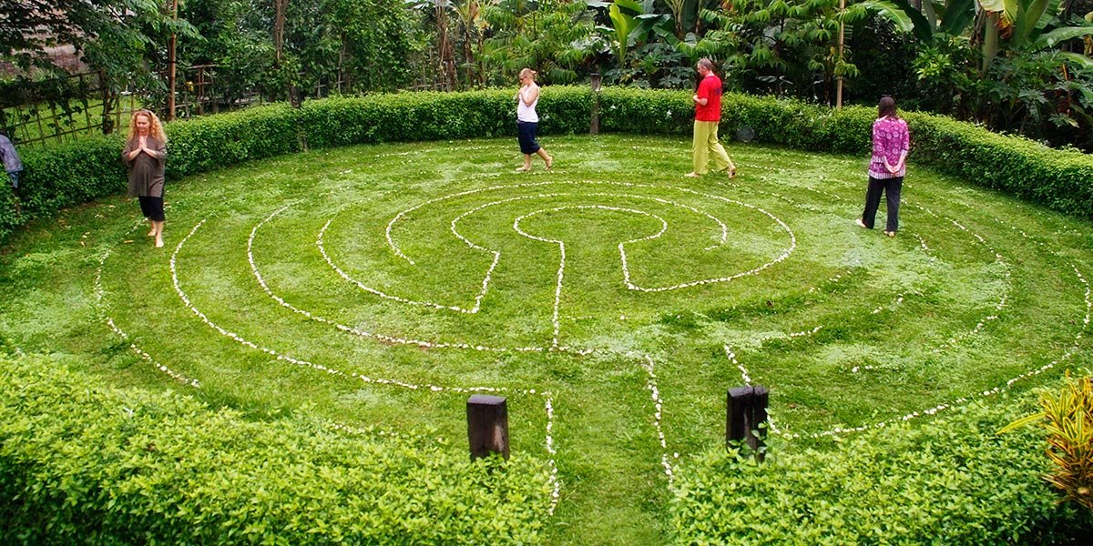 Guests walking a grass labyrinth at Bali Silent Retreat